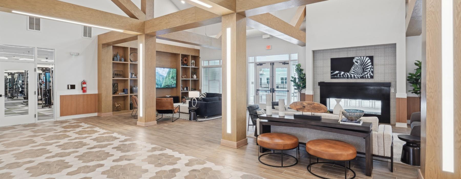 a large clubhouse with a fireplace seating and a table