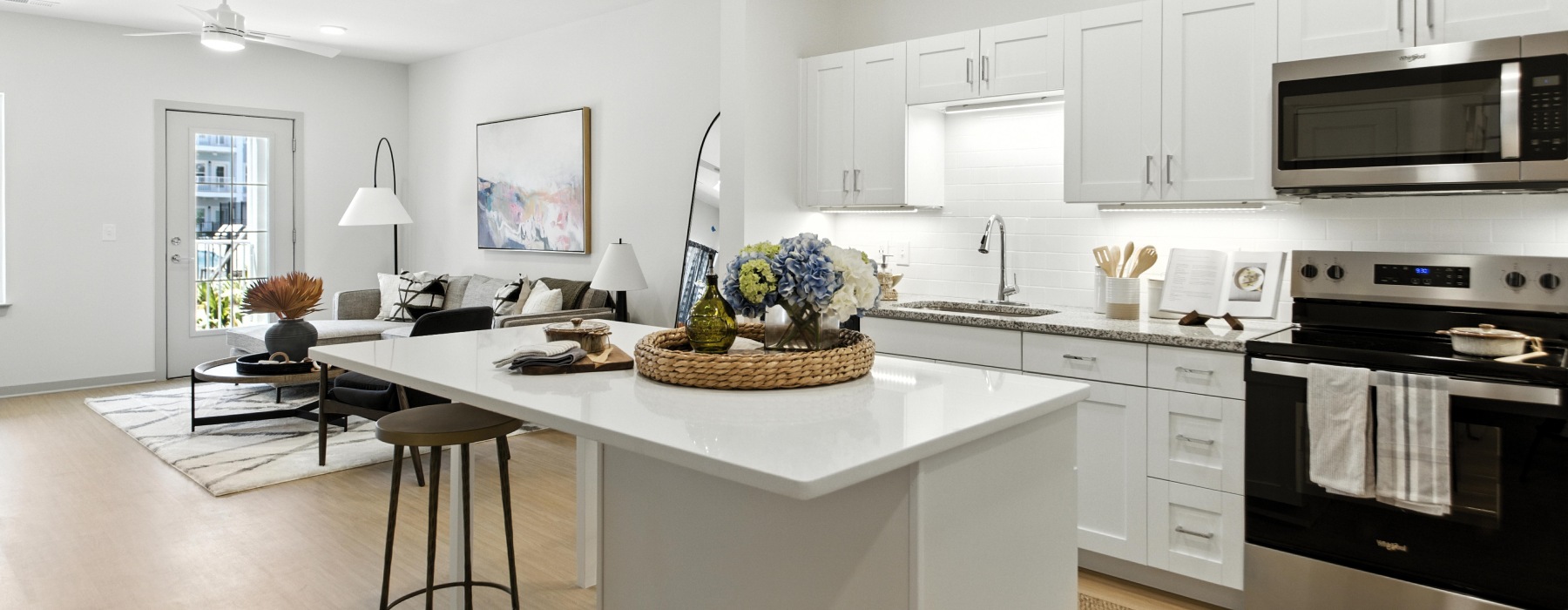 A spacious, brightly-lit kitchen and living space at The Willow luxury apartments in North Charleston, SC.