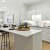 model kitchen with white cabinets and island